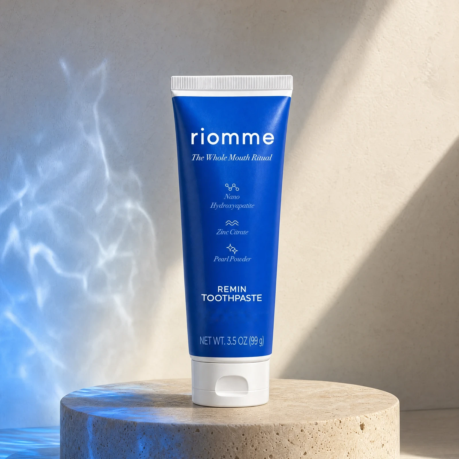 Remin Toothpaste on a round stone pedestal