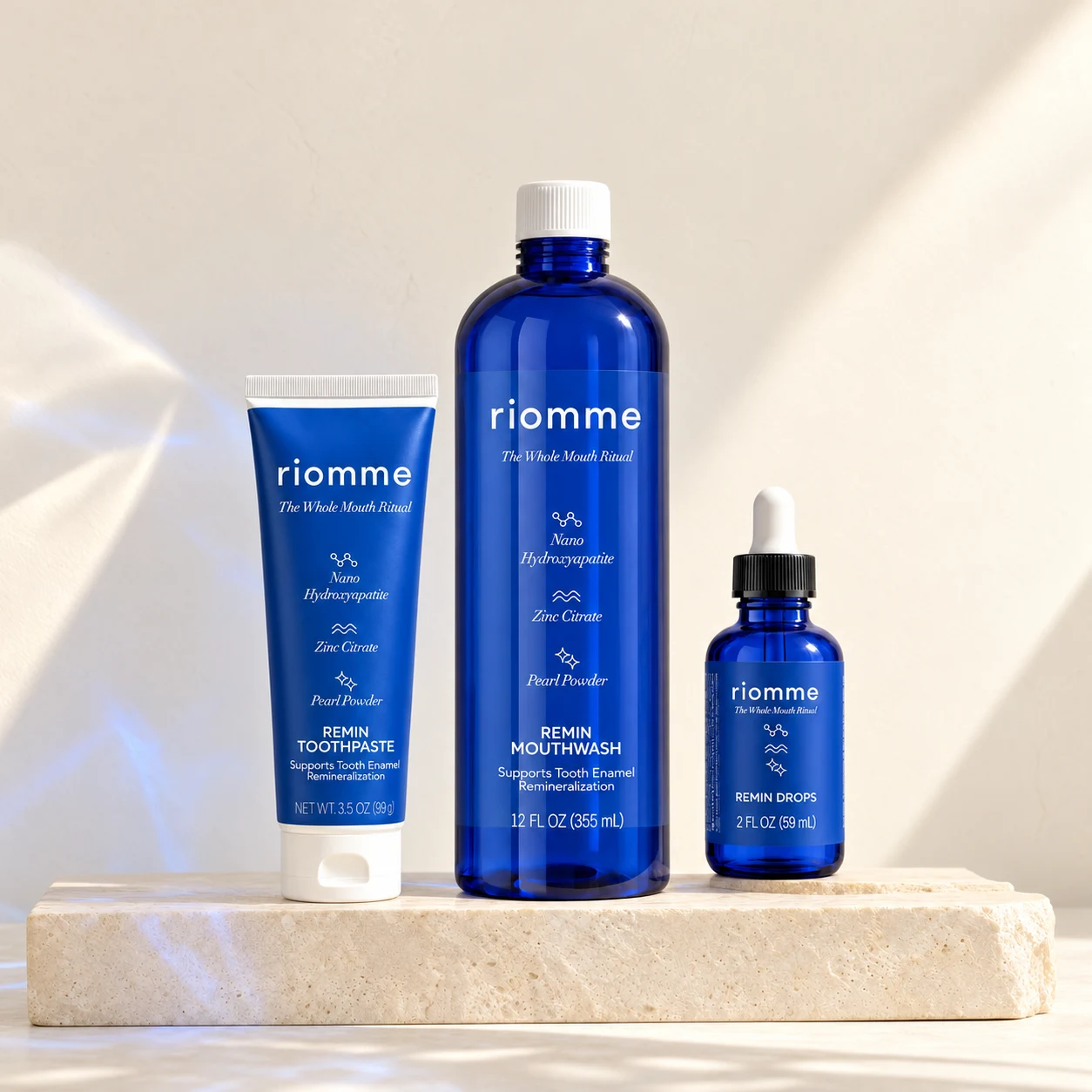 Remin Toothpaste, Remin Mouthwash and Remin Drops on a stone slab